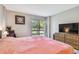 Main bedroom with king bed, TV, and view of the golf course at 2700 Cove Cay Dr # 1-2F, Clearwater, FL 33760