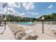 Spacious pool deck area with lounge chairs and patio tables at 2700 Cove Cay Dr # 2F, Clearwater, FL 33760