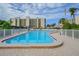 Inviting community pool surrounded by a white fence at 2700 Cove Cay Dr # 2F, Clearwater, FL 33760
