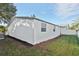 Side yard with white fence and freshly cut grass at 1018 Osprey Ct, Dunedin, FL 34698