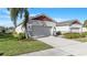 Two-story house with attached garage and landscaped front yard at 10311 Planer Picket Dr, Riverview, FL 33569