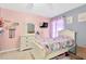 bedroom with pink walls, white furniture, and unicorn decorations at 10641 Navigation Dr, Riverview, FL 33579