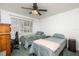 Second bedroom with two twin beds, a ceiling fan, and a window at 11231 Dollar Lake Dr # 6, Port Richey, FL 34668