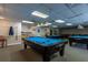 Well-equipped billiard room with multiple pool tables and comfortable seating at 11231 Dollar Lake Dr # 6, Port Richey, FL 34668