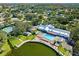 Community pool and clubhouse with lake views, surrounded by lush landscaping at 11231 Dollar Lake Dr # 6, Port Richey, FL 34668