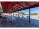 Covered patio area with tables, chairs, and view of the pool at 11231 Dollar Lake Dr # 6, Port Richey, FL 34668
