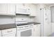 Close-up of the kitchen's white appliances and dark granite countertops at 11231 Dollar Lake Dr # 6, Port Richey, FL 34668