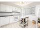Bright kitchen featuring white cabinets, dark countertops, and stainless steel appliances at 11231 Dollar Lake Dr # 6, Port Richey, FL 34668