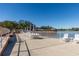 Lakefront patio area with tables, chairs, and umbrellas at 11231 Dollar Lake Dr # 6, Port Richey, FL 34668