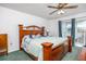 Large main bedroom with wooden furniture, ceiling fan, and access to a patio at 11231 Dollar Lake Dr # 6, Port Richey, FL 34668