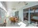 Bright sunroom with sliding glass doors, round table, and chairs at 11231 Dollar Lake Dr # 6, Port Richey, FL 34668