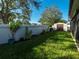 Landscaped backyard with storage shed and fence at 11407 Village Brook Dr, Riverview, FL 33579