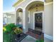 House exterior featuring an arched entryway with a black front door and brick walkway at 11407 Village Brook Dr, Riverview, FL 33579