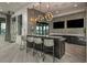 Stylish bar area with granite countertops, pendant lighting, and bar seating at 11726 Renaissance Blvd, Venice, FL 34293