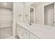 Modern bathroom features a long vanity, bright lighting and a walk-in closet at 11726 Renaissance Blvd, Venice, FL 34293