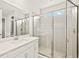 Well-lit bathroom with glass shower, contemporary finishes, and a spacious layout at 11726 Renaissance Blvd, Venice, FL 34293