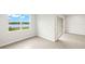 Bright bedroom with a water view from the windows, neutral paint, and tile floors at 11726 Renaissance Blvd, Venice, FL 34293