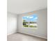 Bedroom with a serene lake view from a large window, neutral paint, and tile flooring at 11726 Renaissance Blvd, Venice, FL 34293