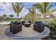 Community fire pit with seating, pool, and lake views at 11726 Renaissance Blvd, Venice, FL 34293