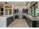 Modern kitchen with dark wood cabinetry, stainless steel appliances, and granite countertops at 11726 Renaissance Blvd, Venice, FL 34293