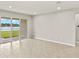 Bright living area with sliding glass doors to a water view and neutral color scheme at 11726 Renaissance Blvd, Venice, FL 34293