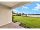 Picturesque view of the green yard and lake from the covered patio at 11726 Renaissance Blvd, Venice, FL 34293