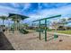 Community playground with swings, slides, and shade structure at 11726 Renaissance Blvd, Venice, FL 34293