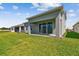 The backyard has a neat lawn and a patio door that opens up to a large grassy area, perfect for outdoor activities at 11846 Mile Marsh Dr, Riverview, FL 33569