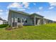Lush green lawn complements this home's exterior, which features a covered patio and ample windows for natural light at 11846 Mile Marsh Dr, Riverview, FL 33569