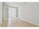 Empty bedroom with double doors, light wood flooring, white walls and baseboards at 11846 Mile Marsh Dr, Riverview, FL 33569