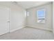 Cozy bedroom with natural light, carpet flooring, and a view to the outside at 11846 Mile Marsh Dr, Riverview, FL 33569