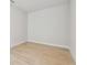 Empty bedroom with light hardwood flooring, white walls and baseboards, awaiting your personal touch at 11846 Mile Marsh Dr, Riverview, FL 33569