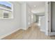Bright and airy hallway with wood flooring and neutral paint at 11846 Mile Marsh Dr, Riverview, FL 33569