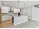 Stylish kitchen featuring a center island, sleek cabinetry, and modern lighting fixtures at 11846 Mile Marsh Dr, Riverview, FL 33569