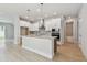 Modern kitchen with white cabinets, stainless steel appliances, and a large island at 11846 Mile Marsh Dr, Riverview, FL 33569