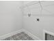 Bright laundry room with black and white patterned tile floor and a white utility sink at 11846 Mile Marsh Dr, Riverview, FL 33569