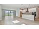 Open concept living space combining living and kitchen areas with sliding glass door at 11846 Mile Marsh Dr, Riverview, FL 33569