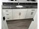 Vanity in new bathroom with grey vinyl flooring, granite countertop, and white shaker cabinets at 12186 Lamont Dr, Spring Hill, FL 34608