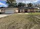 Single-story house with attached garage and yard at 12186 Lamont Dr, Spring Hill, FL 34608