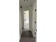 Hallway with modern trim, gray flooring, and access to a bedroom for comfortable living at 12186 Lamont Dr, Spring Hill, FL 34608