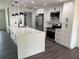 Bright kitchen features a large island with white countertop, stainless steel appliances and dark hardware at 12186 Lamont Dr, Spring Hill, FL 34608