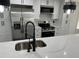 Modern kitchen with stainless steel appliances, white cabinets, and an island with sink at 12186 Lamont Dr, Spring Hill, FL 34608