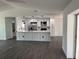 A modern kitchen boasts white cabinets, stainless steel appliances, and a center island with bar seating at 12186 Lamont Dr, Spring Hill, FL 34608