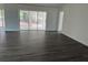 Open concept living area with gray vinyl flooring and sliding doors leading to the patio at 12186 Lamont Dr, Spring Hill, FL 34608
