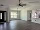 An open-concept living room is filled with natural light and features stylish flooring and modern light fixtures at 12186 Lamont Dr, Spring Hill, FL 34608