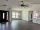 An open-concept living room is filled with natural light and features stylish flooring and modern light fixtures at 12186 Lamont Dr, Spring Hill, FL 34608