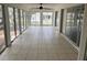 Enclosed sunroom with tiled floor and multiple windows, bringing the outdoors in for versatile living space at 12186 Lamont Dr, Spring Hill, FL 34608