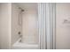 Bathroom with shower/tub combo and tiled walls at 1230 Gulf Blvd # 402, Clearwater Beach, FL 33767