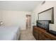 Bedroom with bed, dresser, TV, and ensuite bathroom access at 1230 Gulf Blvd # 402, Clearwater Beach, FL 33767