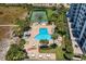 Inviting community pool with ample seating, a tennis court, and lush landscaping at 1230 Gulf Blvd # 402, Clearwater Beach, FL 33767